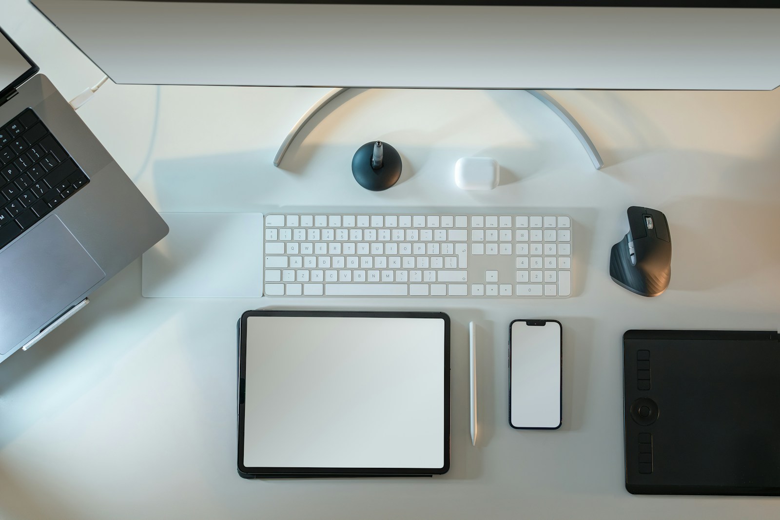 a desk with a computer, keyboard, mouse, and other items